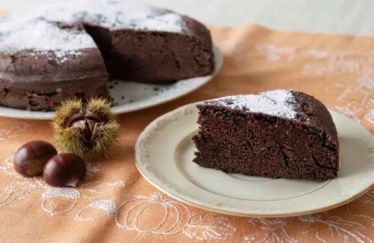 Torta di castagne e cioccolato senza burro marrone scuro e spumosa con zucchero a velo